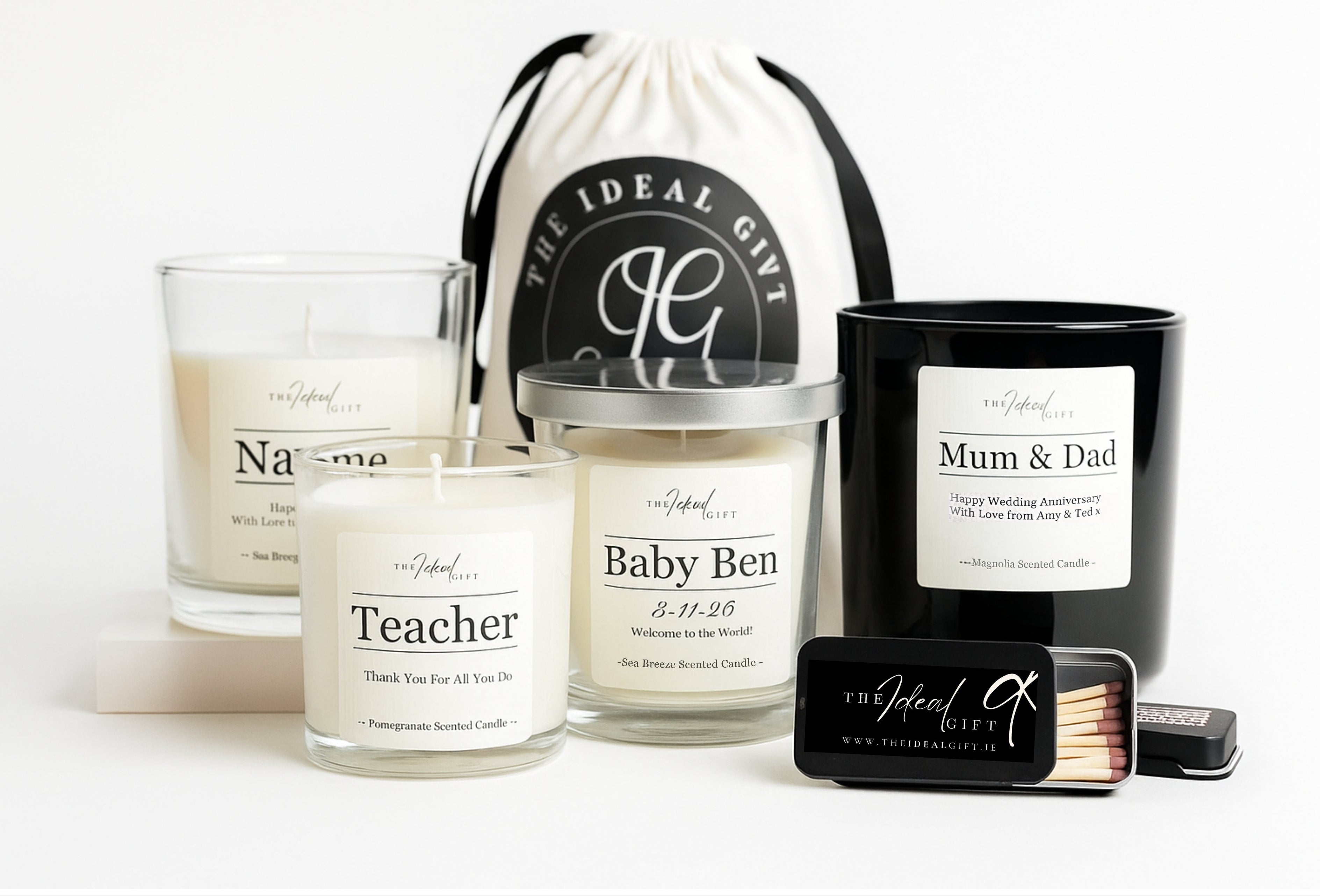 Collection of personalized candles and a matchbox on a white background